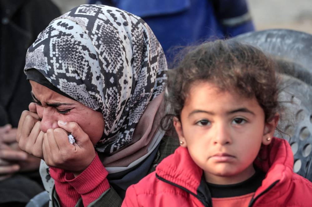 A woman mourns following overnight Israeli strikes in Deir El-Balah in central Gaza on Saturday. AFP