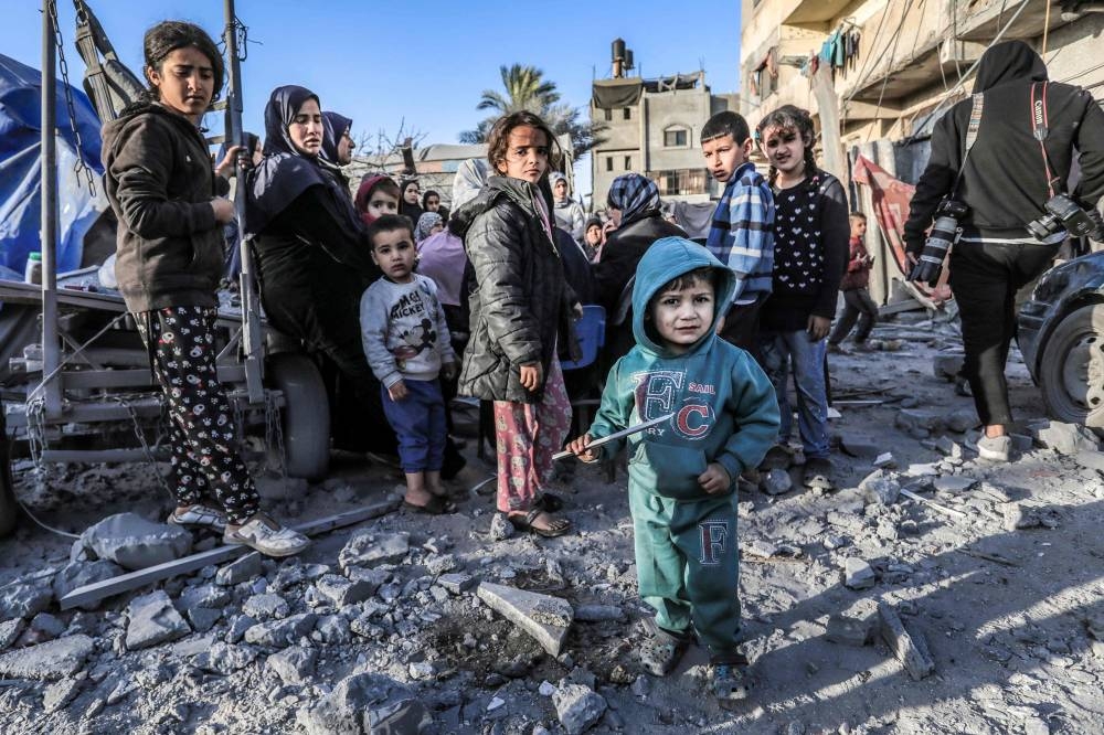 Children stand amid the rubble of a Mosque and makeshift shelters that were destroyed in Israeli strikes in Deir El-Balah in central Gaza on Saturday. AFP