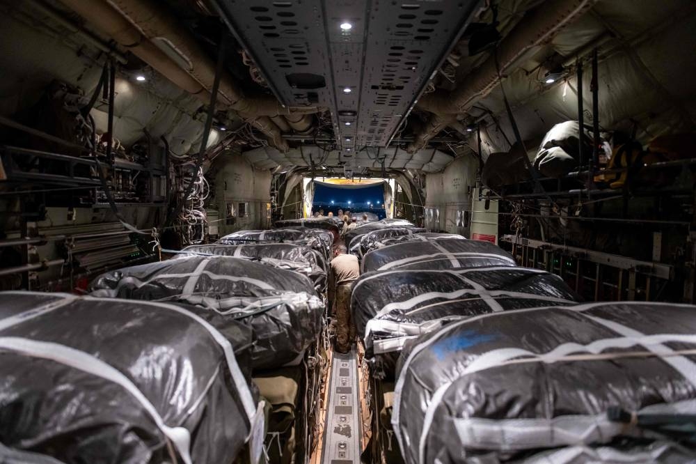 Humanitarian aid pallets rigged with parachutes for an airdrop over Gaza aboard a C-130J Super Hercules are loaded and prepared for takeoff at an undisclosed location in Southwest Asia, on Friday. AFP/US Department of Defense/US Air Force/Tech. Sgt. Christopher Hubenthal