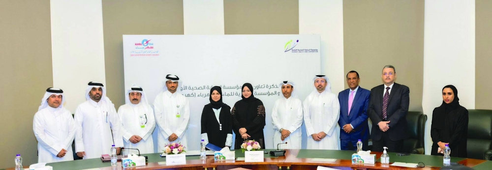 Kahramaa's Dr al-Wahidi and PHCC's Dr al-Abdulla and other officials at the signing ceremony.