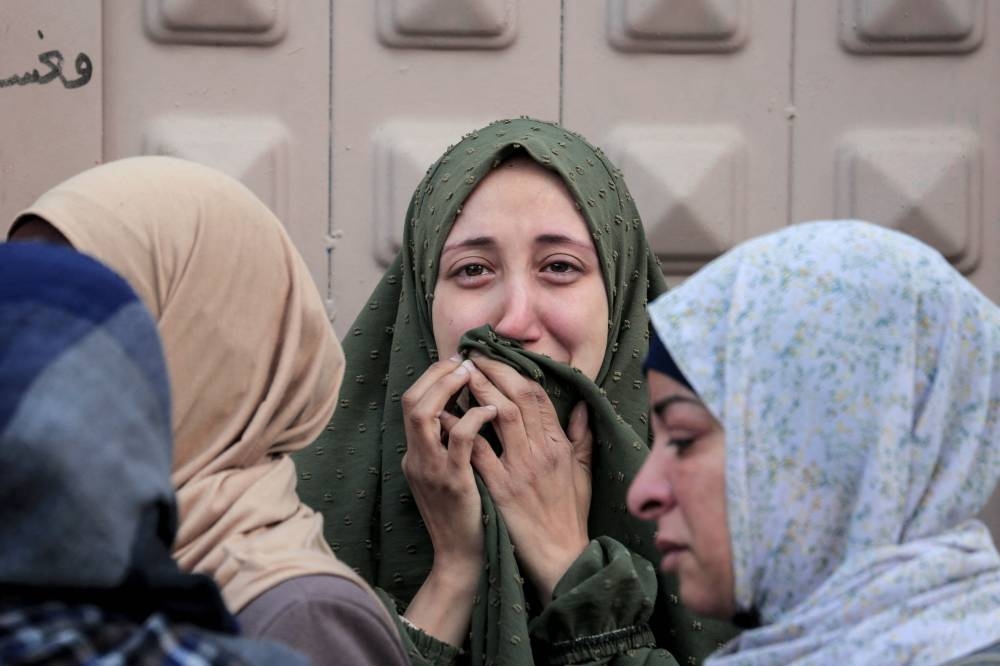 Palestinians react at al-Aqsa hospital in Deir el-Balah as people mourn the death of loved ones killed during Israeli bombardment, in the central Gaza Strip on Wednesday. AFP