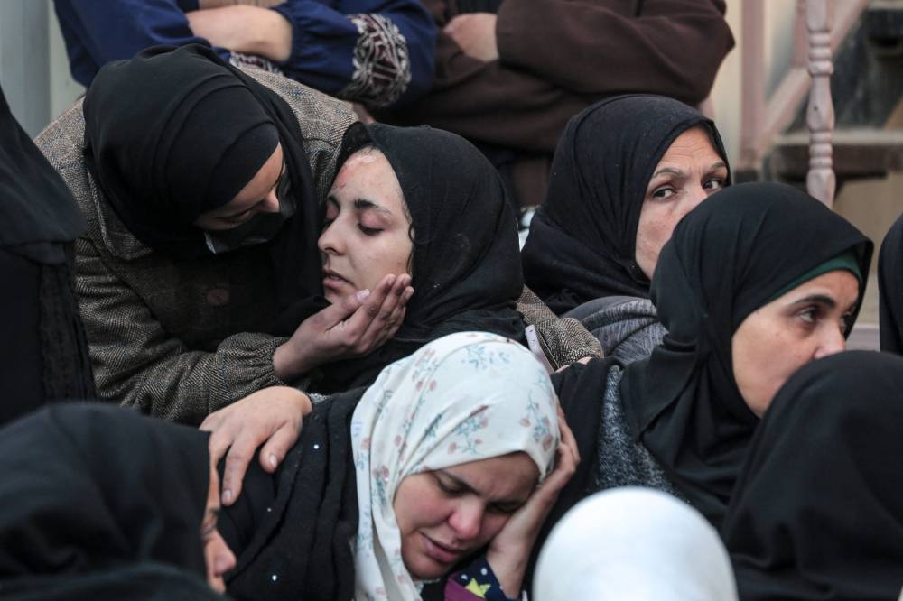 Palestinians react at al-Aqsa hospital in Deir el-Balah as people mourn the death of loved ones killed during Israeli bombardment, in the central Gaza Strip on Wednesday. AFP