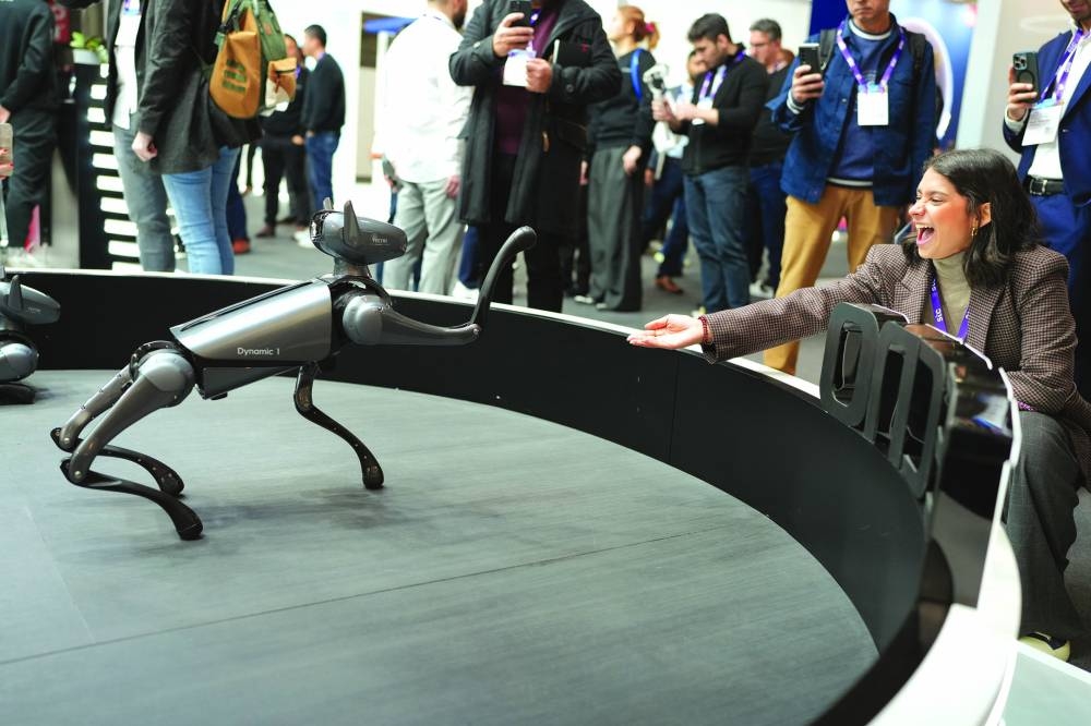 INTERACTION: An attendee banters with a prototype robot at the MWC24 in Barcelona. (GSMA photo)