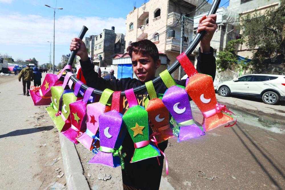 A displaced Palestinian child sells handmade Ramadan lanterns in Rafah in the southern Gaza Strip, yesterday, amid the ongoing conflict.