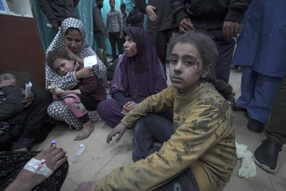 Wounded Palestinians arrive for treatment at the Al-Aqsa Martyrs Hospital after Israeli bombardment in Deir Balah in the central Gaza Strip on Saturday. AFP