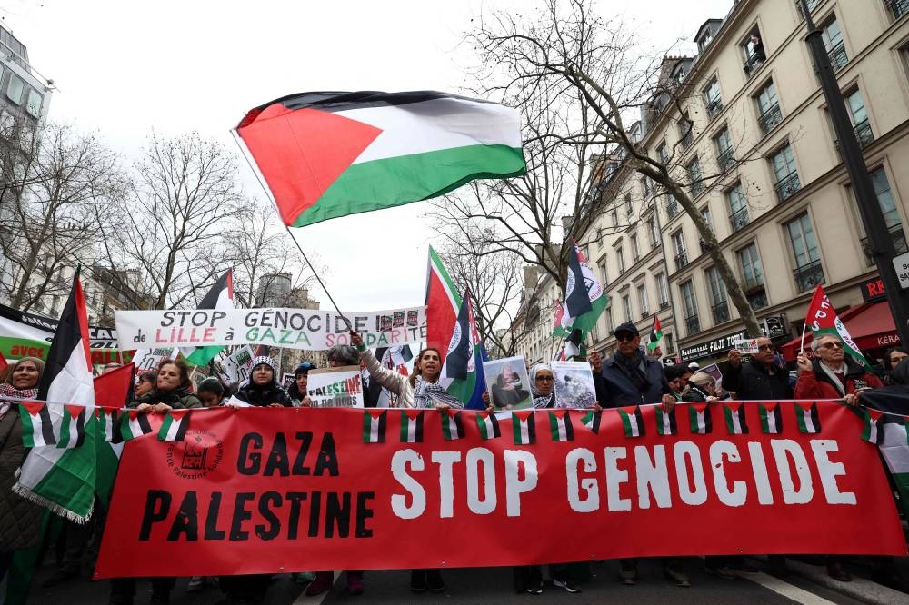 
Protesters hold a banner reading “stop genocide” during a demonstration calling for an immediate ceasefire in the Gaza strip, at the Place de la Republique in Paris, France, yesterday. 