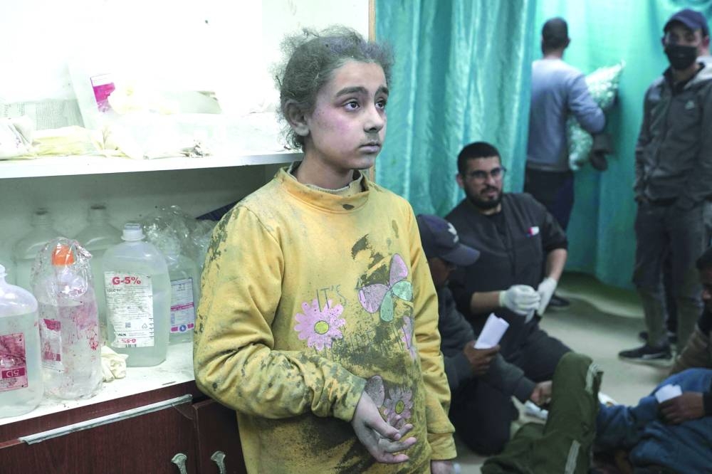 
A wounded Palestinian awaits treatment at the Al-Aqsa Martyrs Hospital after Israeli bombardment in Deir Balah in the central Gaza Strip, yesterday. 