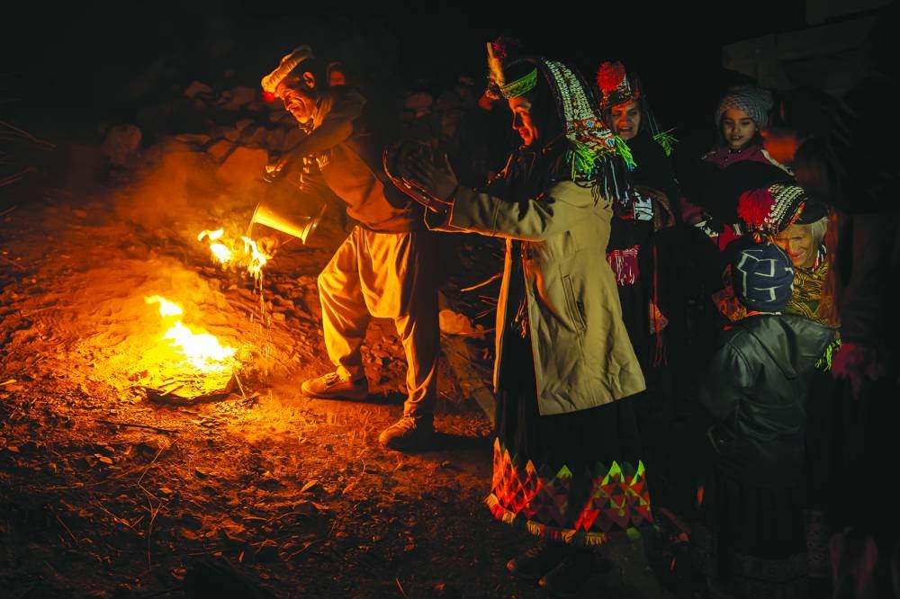 A man performing the purification ceremony for his female relatives on purification night (Female Purification, 2021, Choimous Festival series). – Image courtesy of Fatema bint Ahmed and Tasweer Photo Festival Qatar
