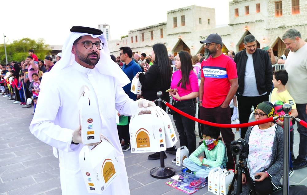 People who had gathered to witness the cannon firing are being offered food kits to break the fasting of the first day of Ramadan this year. PICTURE: Shaji Kayamkulam