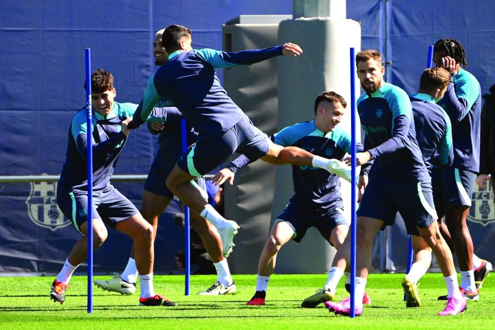 Barcelona’s players train on the eve of their UEFA Champions League last 16 second leg match against SSC Napoli at the training centre in Barcelona on Monday. (AFP)