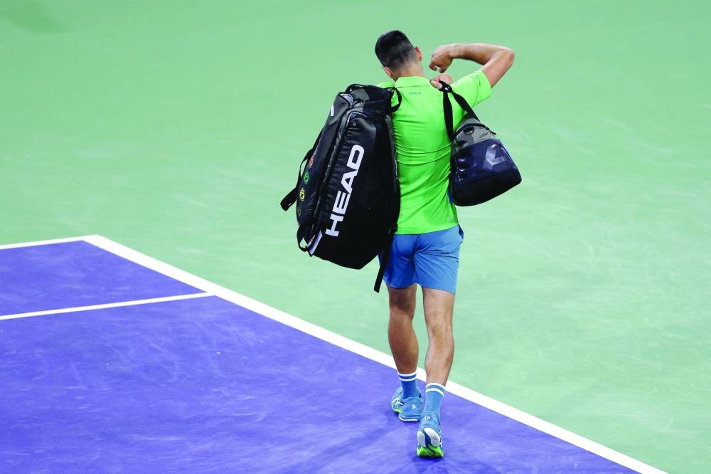 
Novak Djokovic of Serbia leaves the court after losing to Luca Nardi of Italy during the BNP Paribas Open at Indian Wells Tennis Garden in Indian Wells, California. Right: Nardi celebrates his win. (AFP) 