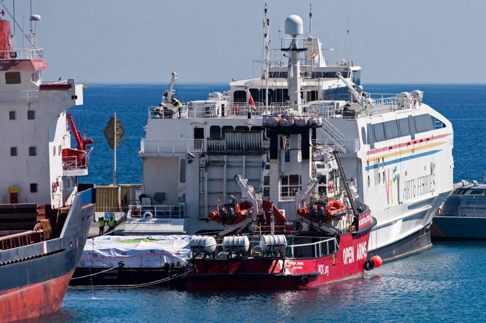 The Open Arms vessel (C), carrying two-hundred tonnes of food aid to Gaza Strip, is seen docked in the Cypriot port of Larnaca on March 11. Iakovos Hatzistavrou / AFP