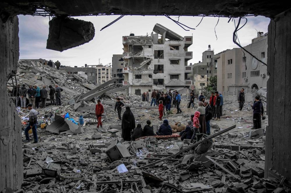 Palestinians inspect the rubble of a building, after it was destroyed in an Israeli strike the night before, in the Rimal neighbourhood of Gaza City on Saturday. AFP