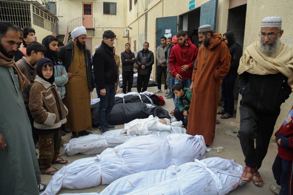 Palestinians mourn at the Al-Aqsa Martyrs Hospital in Deir al-Balah next to bodies of victims pulled from the rubble of the Tabatibi family home on Saturday, following overnight Israeli bombardment west of the Nuseirat refugee camp in the central Gaza Strip. AFP