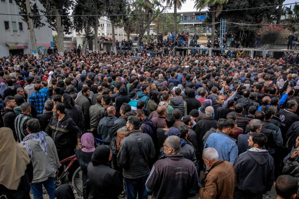 Palestinians queue during the distribution of humanitarian aid in Gaza City on Sunday. AFP