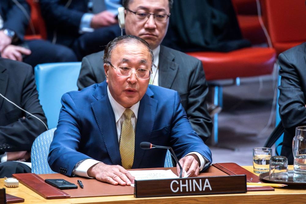 China's ambassador to the United Nations, Zhang Jun, speaks to delegates after voting against a US ceasefire resolution for the Gaza war during a UN Security Council meeting at the United Nations headquarters on Friday. AFP