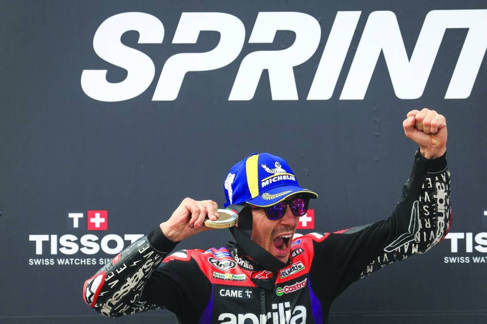 
Aprilia’s Maverick Vinales celebrates on the podium after winning the sprint race.  