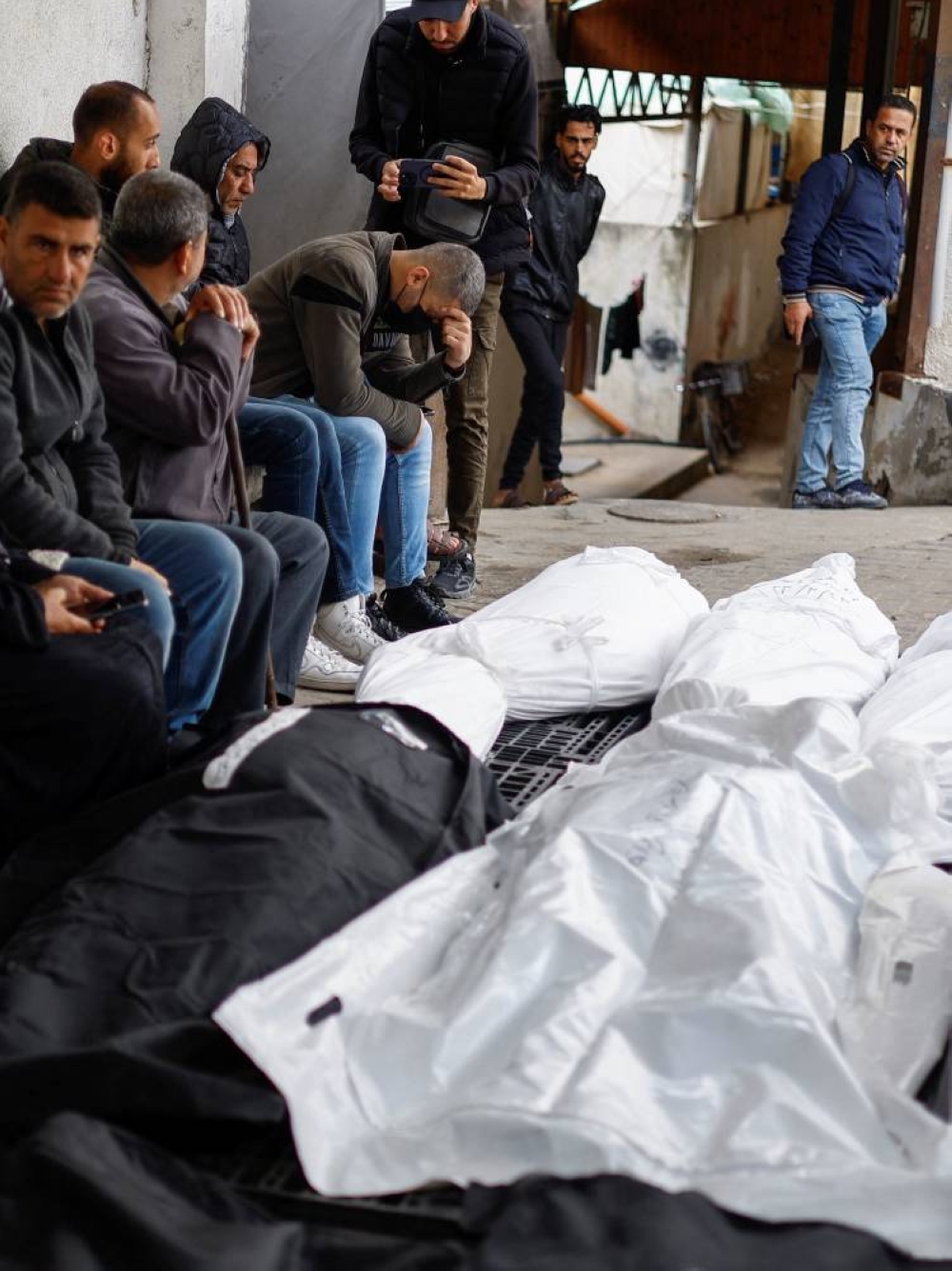 Mourners react next to the bodies of Palestinians killed in an Israeli strike in the southern Gaza Strip, on Sunday. REUTERS