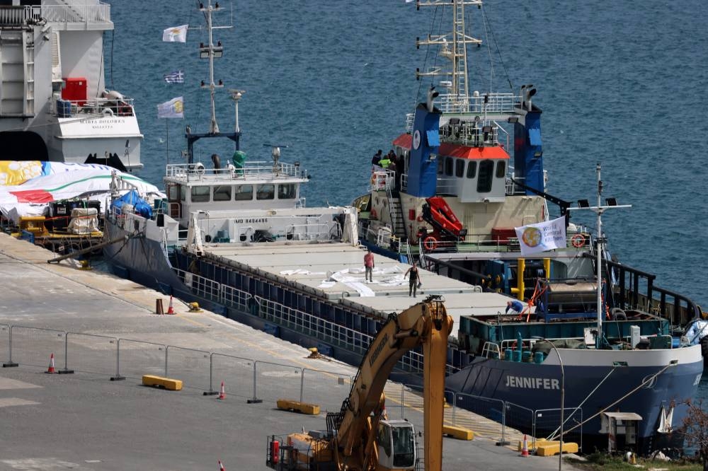 Members of the crew work on a cargo ship loaded with humanitarian aid for Gaza at the port of Larnaca, Cyprus, on Tuesday. REUTERS