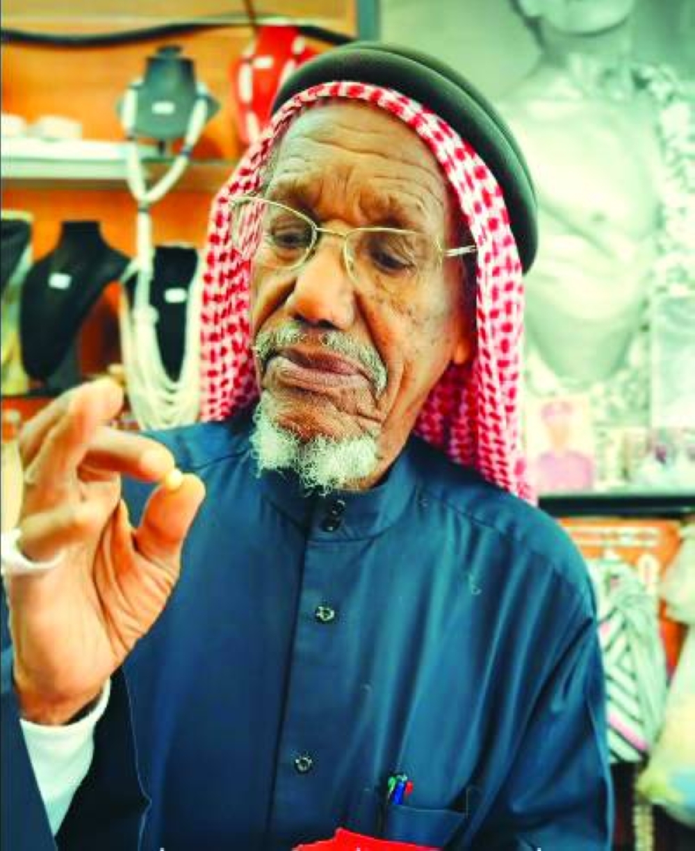 Saad Ismael Khalifa al-Jassim showcases some of the pearls at his shop at Souq Waqif. -screengrab from Visit Qatar's FB page