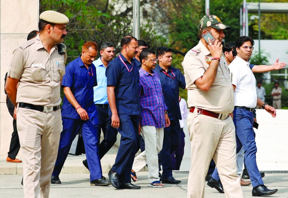 Police officers escort Delhi chief minister and Aam Aadmi Party (AAP) leader Arvind Kejriwal as he leaves court after a hearing in New Delhi, India, on Thursday.