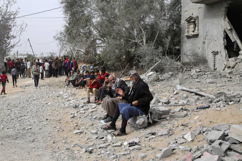 Palestinians gather at the site of an Israeli strike on a house in Khan Younis in the southern Gaza Strip, on Friday. REUTERS