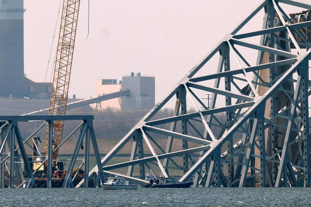 A search team uses a remotely operated underwater vehicle to look at the wreckage of the Francis Scott Key Bridge, which was destroyed when a cargo ship collided with it earlier this week, on Friday in Baltimore.  AFP