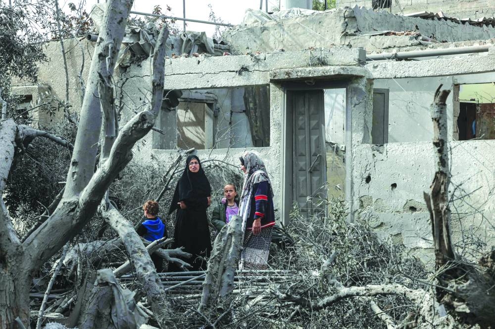 Palestinians inspect the damage to a building after overnight Israeli bombardment in Rafah in the southern Gaza Strip Friday.