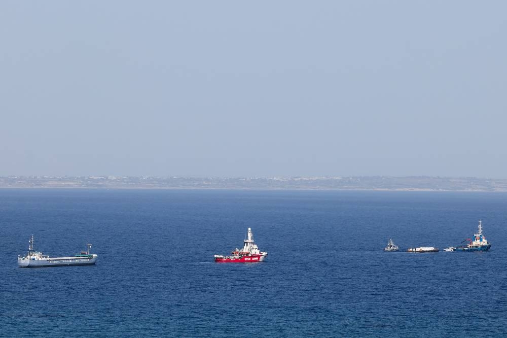 The Open Arms, a rescue vessel owned by a Spanish NGO, a cargo ship and a tug boat depart with humanitarian aid for Gaza from Larnaca, Cyprus, on Saturday. REUTERS