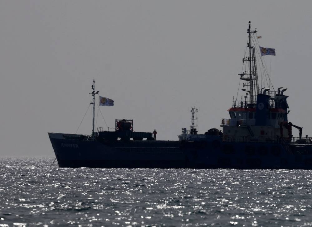 A man stands on board a cargo ship loaded with humanitarian aid for Gaza outside the port of Larnaca, Cyprus, on Saturday. REUTERS