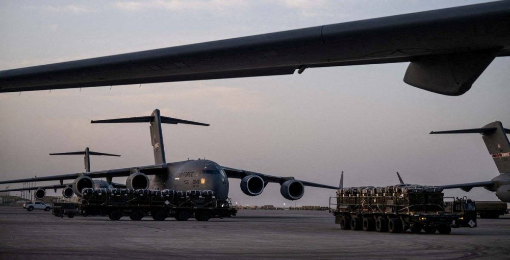 Humanitarian aid for Gaza is seen outside a US air force aircraft at an unidentified location in this handout image released on Friday. US Central Command Via X/Handout via REUTERS. 