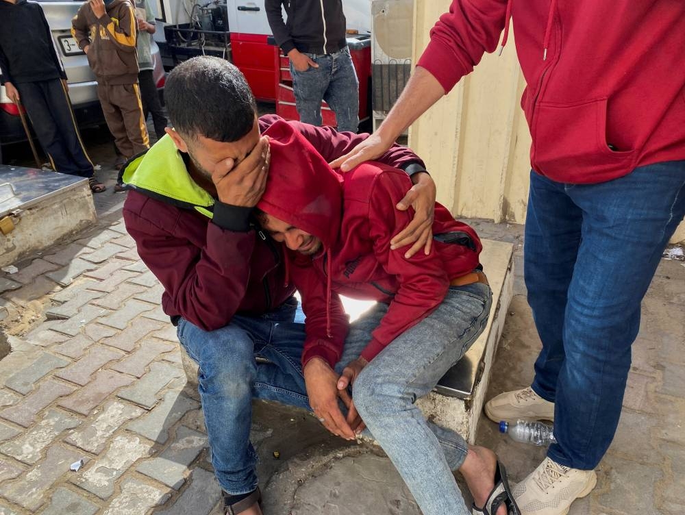 Mourners react during the funeral of Palestinian aid truck driver Ismail Abed al-Daya, who was killed in an Israeli strike according to health officials at Al-Aqsa hospital in Deir Al-Balah in the central Gaza Strip on Sunday. REUTERS