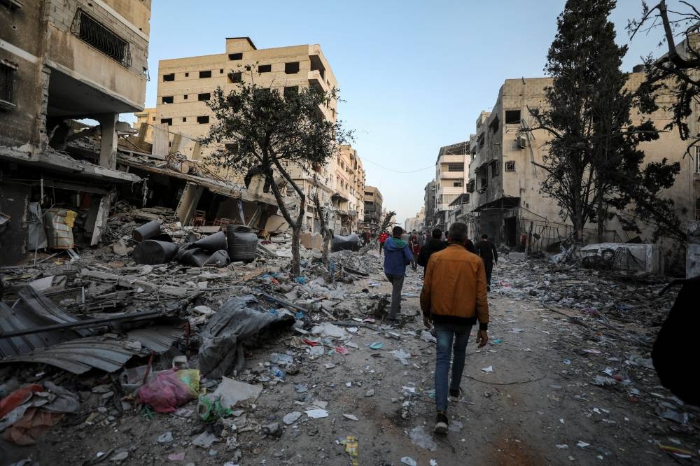 Palestinians inspect the damages at the area around Al Shifa Hospital following a two-week Israeli operation. REUTERS