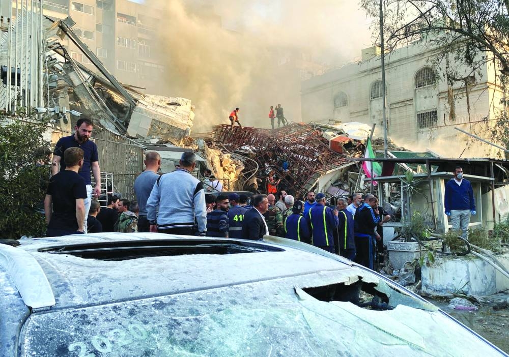 Smoke rises after the Israeli strike on a building close to the Iranian embassy in Damascus, Monday.