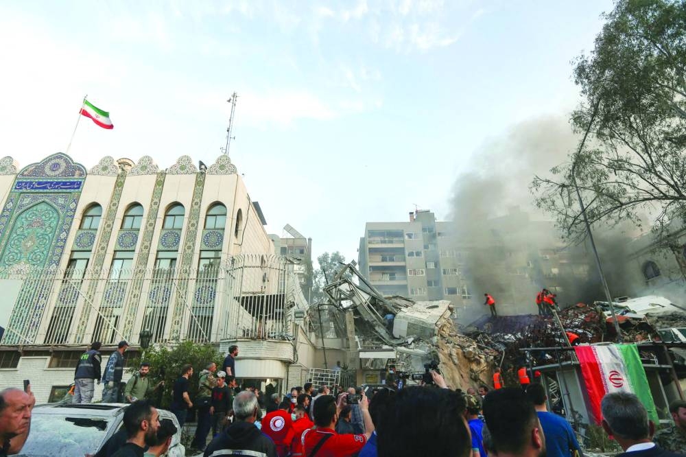 Emergency personnel search the rubble at the site of strikes which hit a building annexed to the Iranian embassy in Syria's capital Damascus, Monday.