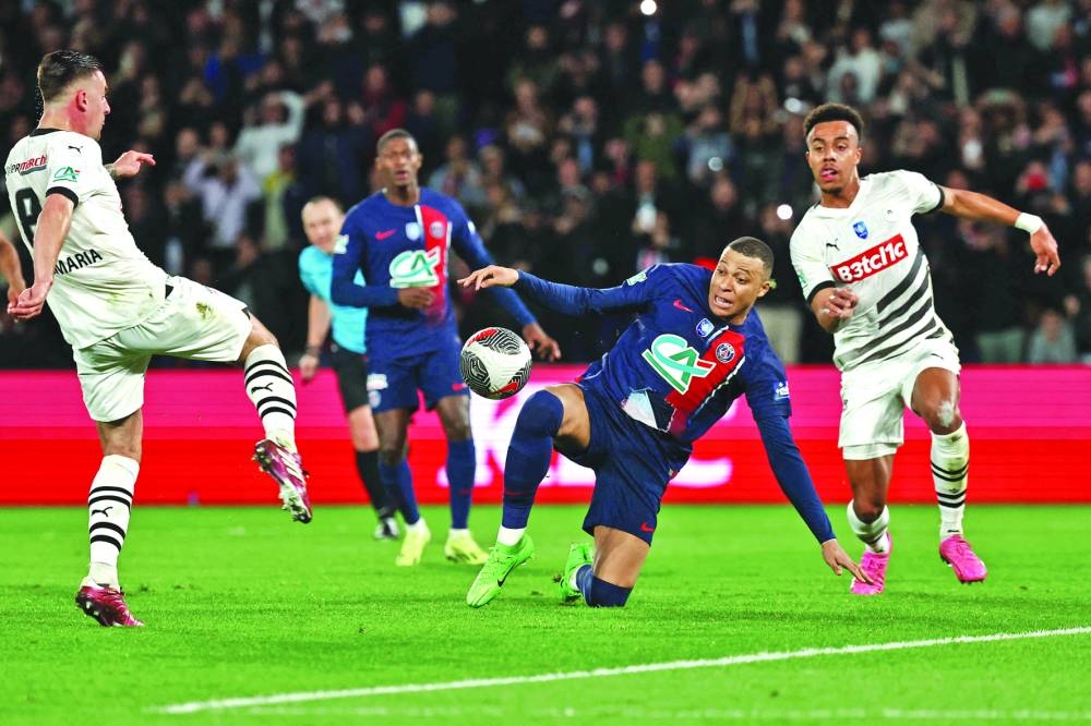 
Paris Saint-Germain’s Kylian Mbappe (centre) vies for the ball with Rennes’ Baptiste Santamaria (left) and Guela Doue during the French Cup semi-final on Wednesday. (AFP) 
