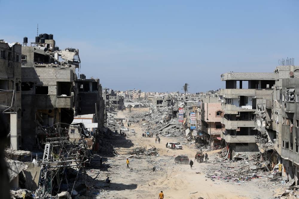 Palestinians inspect destroyed residential buildings, after the Israeli military withdrew most of its ground troops from the southern Gaza Strip, in Khan Younis, in the southern Gaza Strip, on Sunday. REUTERS