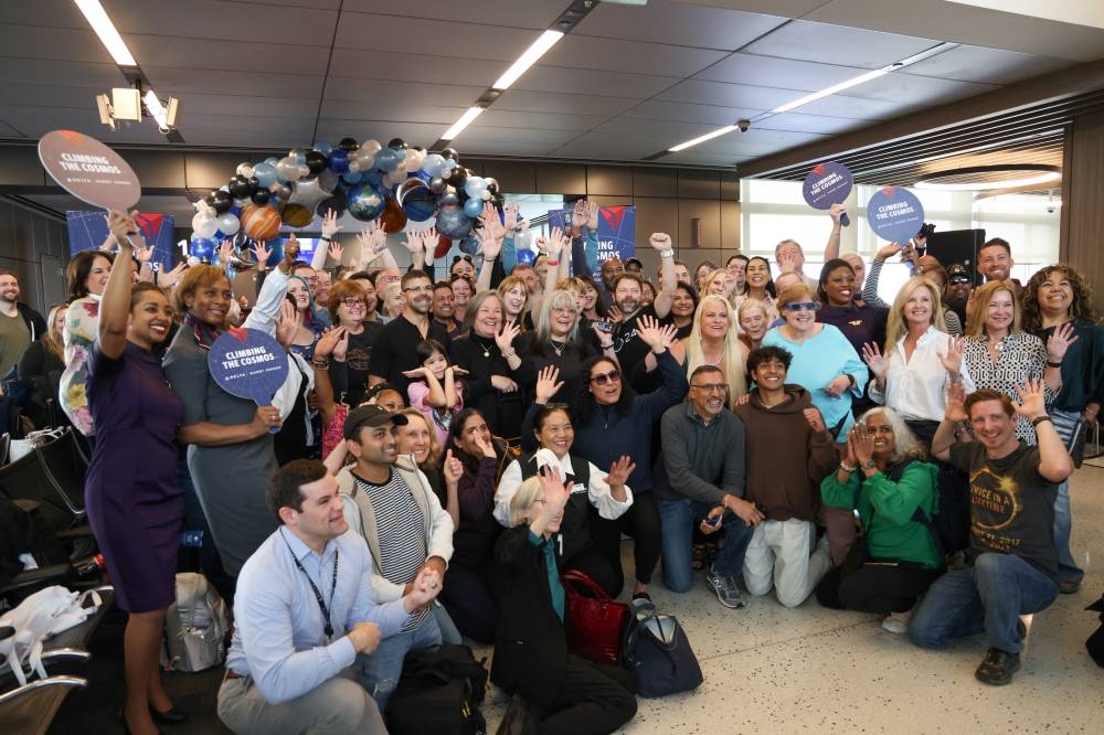 People pose for a portrait before boarding a solar eclipse flight to Detroit from Austin, Texas, Monday. REUTERS