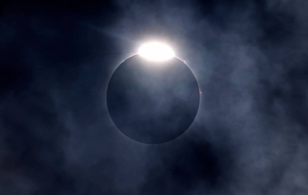 The diamond ring effect as well as Bailey's Beads are seen as the moon eclipses the sun on Monday in Fort Worth, Texas. AFP