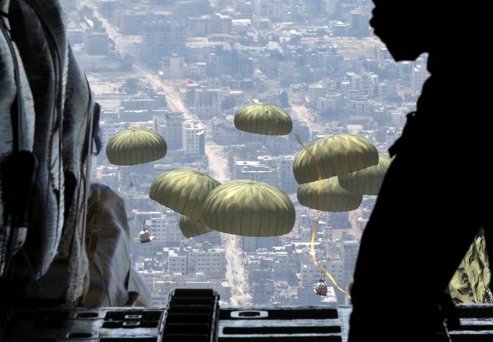 Members of Jordanian armed forces air drop aid parcels over Gaza, ahead of the celebration of Eid al-Fitr, on Tuesday. REUTERS
