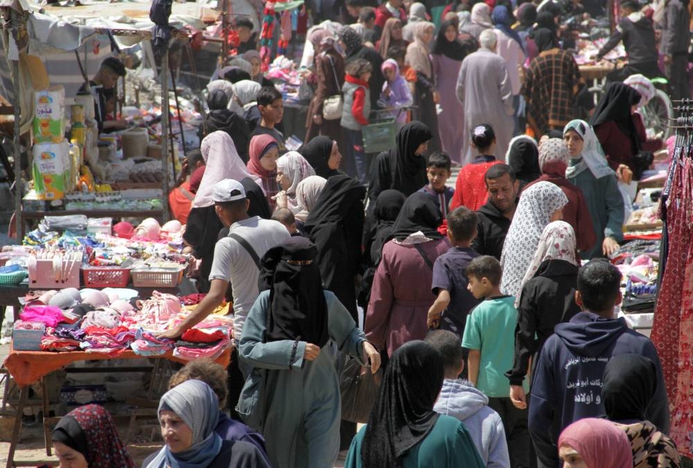 Palestinians shop as they prepare for the upcoming Eid al-Fitr in northern Gaza Strip, on Tuesday. REUTERS