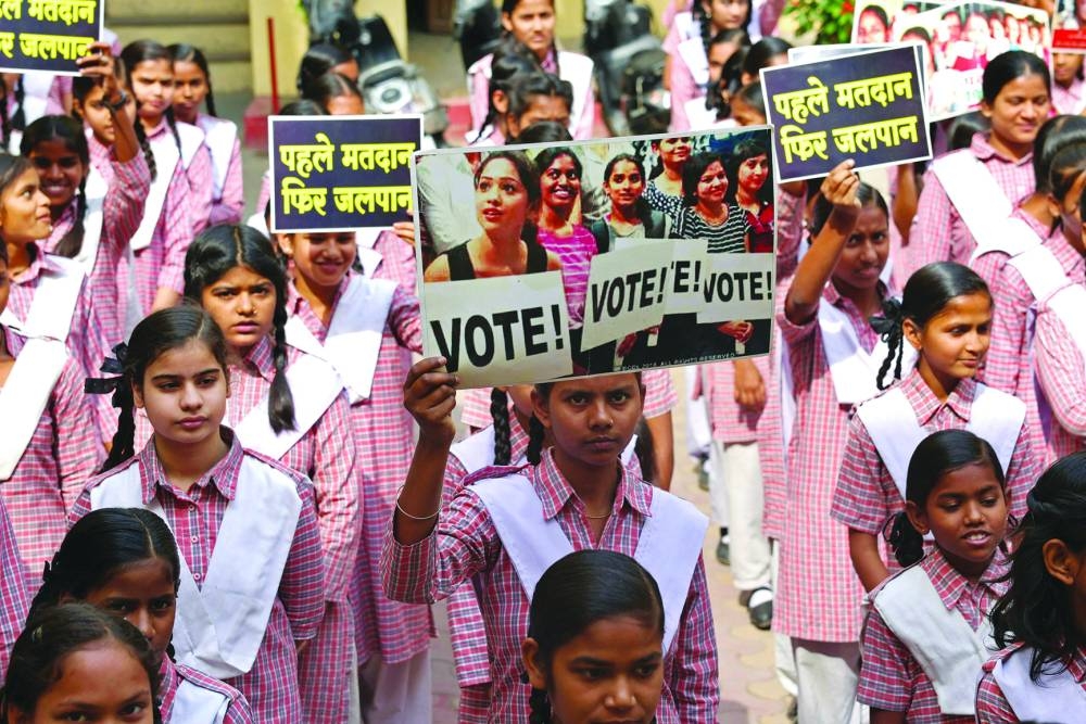 College students hold placards to create awareness for citizens to vote, in Varanasi on Wednesday, ahead of the India’s upcoming general elections.