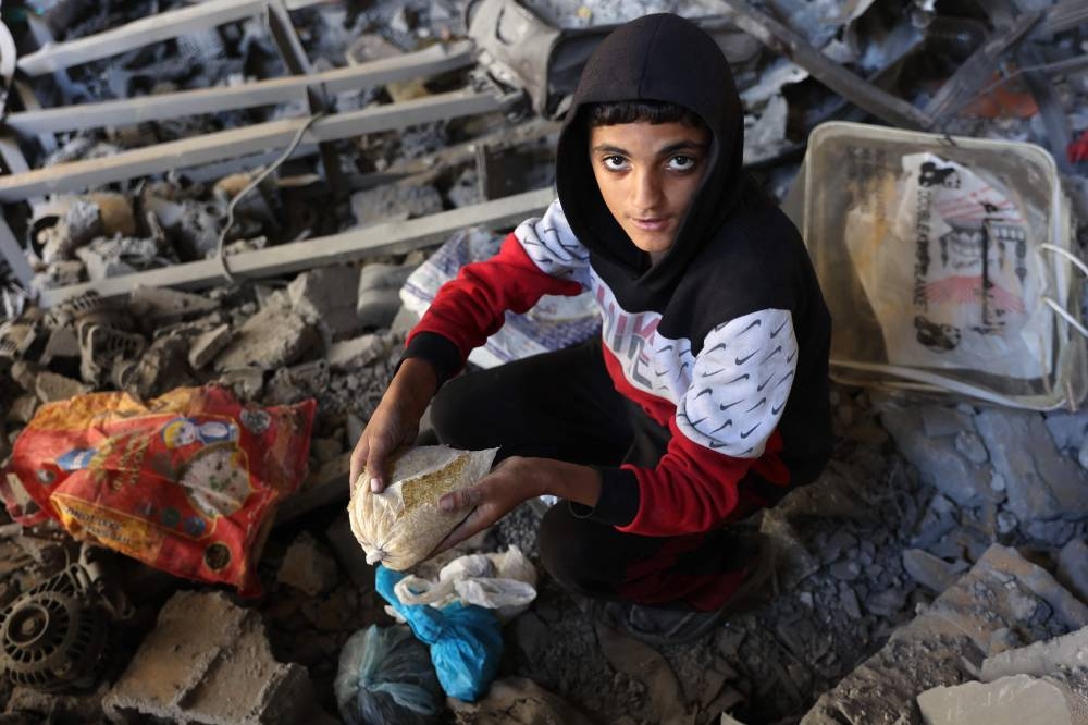 A Palestinian inspects the damage to the home of the Tabatibi family after Israeli bombardment in the Daraj Neighbourhood of Gaza, on Friday. AFP