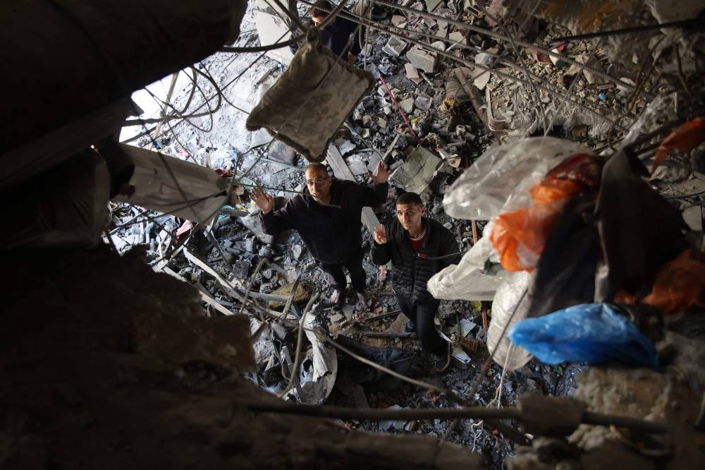 Palestinians inspect the damage to the home of the Tabatibi family after Israeli bombardment in the Daraj Neighbourhood of Gaza, on Friday. AFP