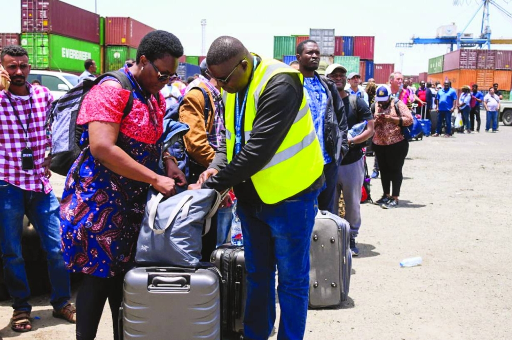 
File photo shows people fleeing war-torn Sudan queue to board a boat from Port Sudan, amid the ongoing conflict in the country between the army and paramilitaries. 