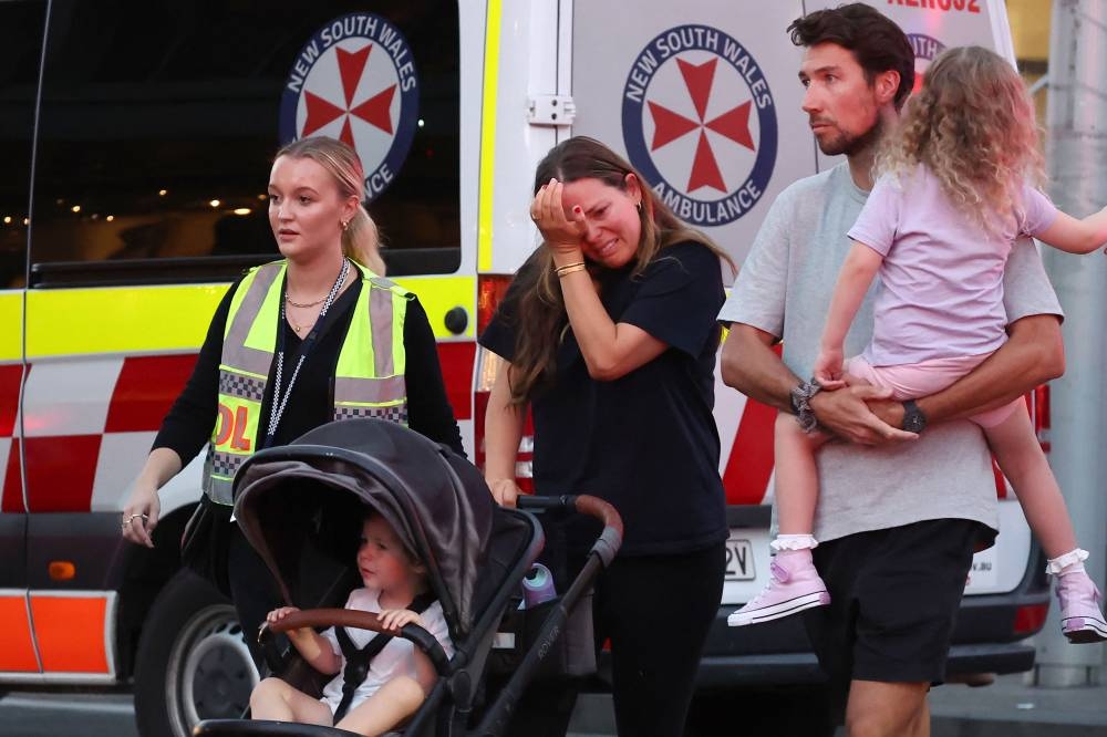 A woman cries as she comes out of the Westfield Bondi Junction shopping mall after a stabbing incident in Sydney on Saturday. AFP