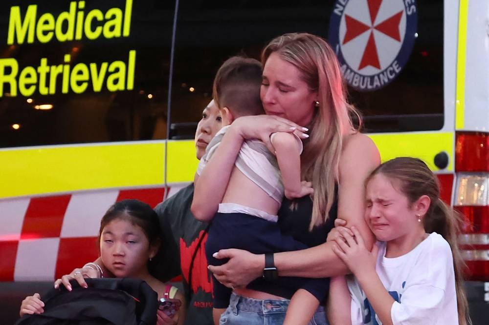 A family leaves the Westfield Bondi Junction shopping mall after a stabbing incident in Sydney on Saturday. AFP