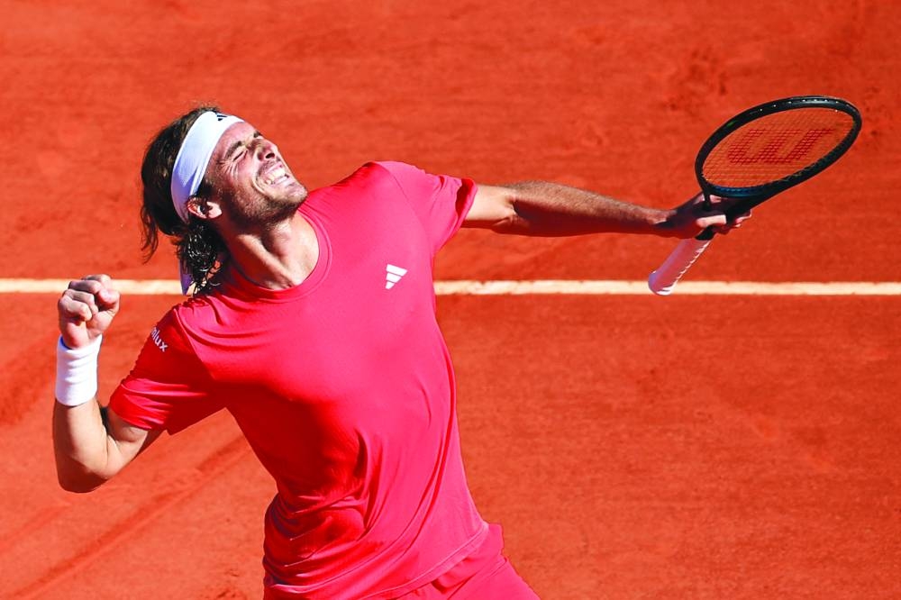 Greece’s Stefanos Tsitsipas celebrates after winning against Italy’s Jannik Sinner in Monaco on Saturday. (AFP)
