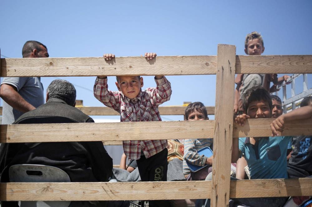 Children look on at a camp for displaced Palestinians in Rafah, in the southern Gaza Strip, on Sunday. AFP