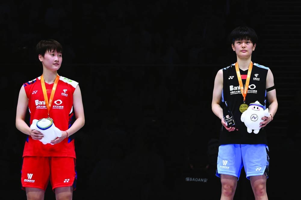 
China’s Wang Zhi Yi (right) poses on the podium after winning her women’s Badminton Asia Championships final against compatriot Chen Yu Fei yesterday. (AFP) 